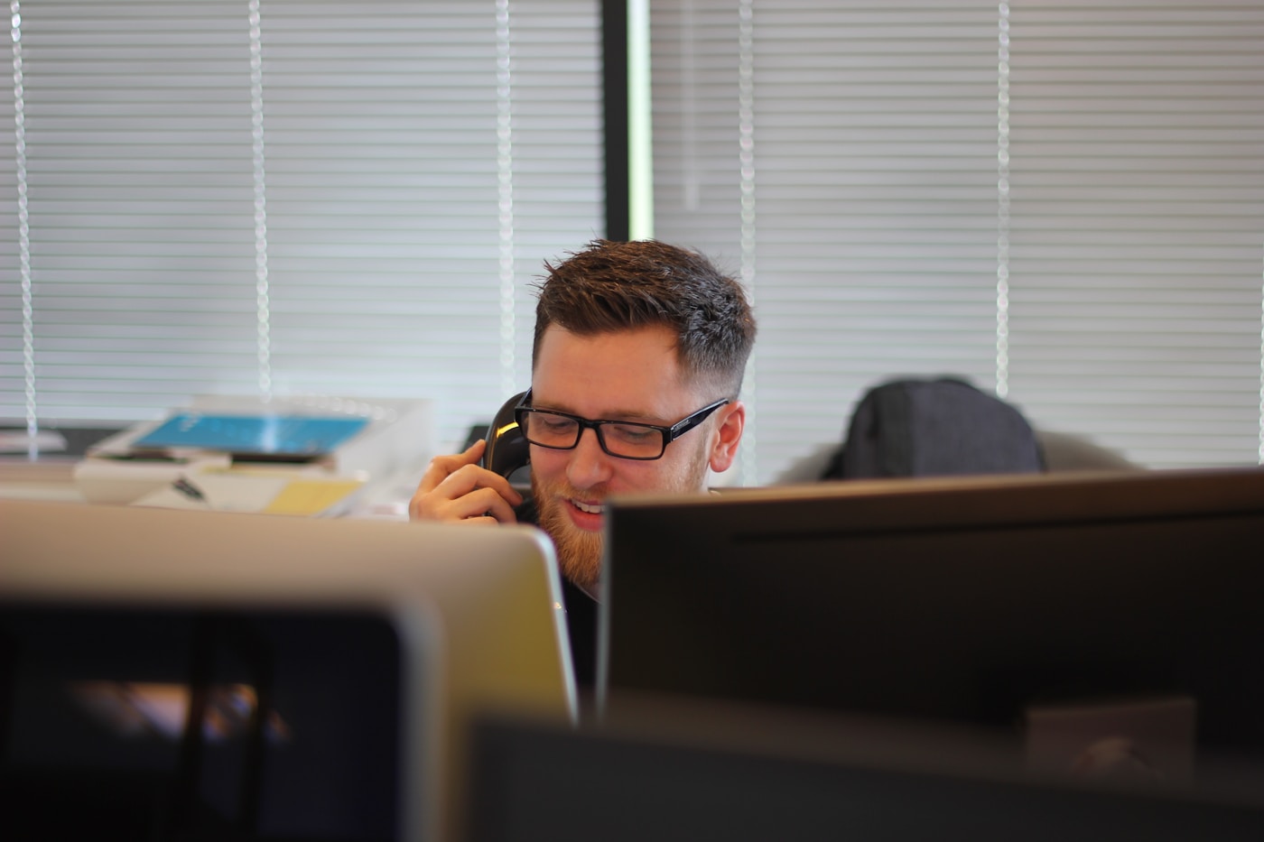 Office worker on a desk phone following up with a caller
